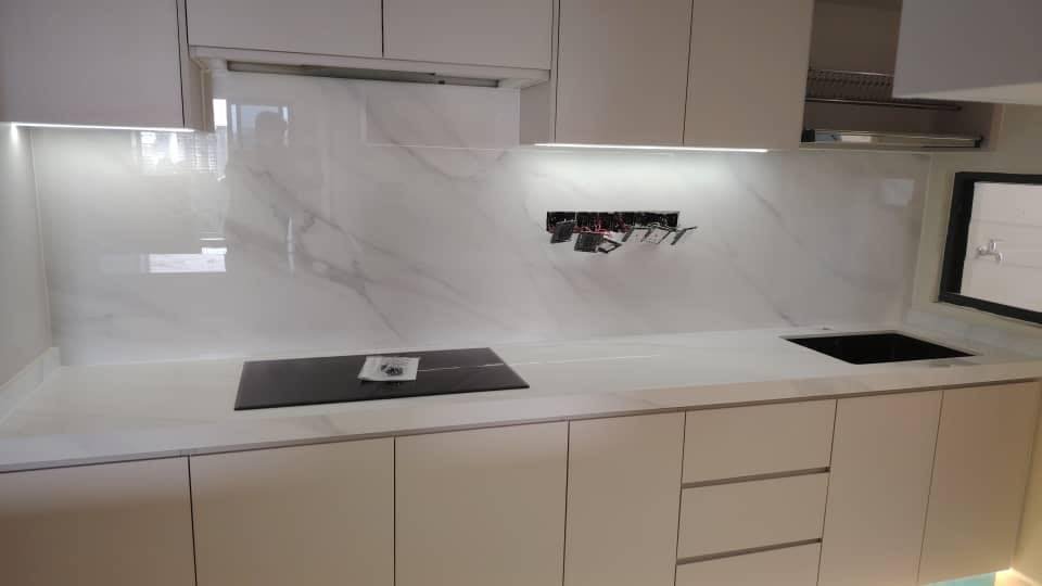 ustom white kitchen cabinet with grey countertop and tiled backsplash